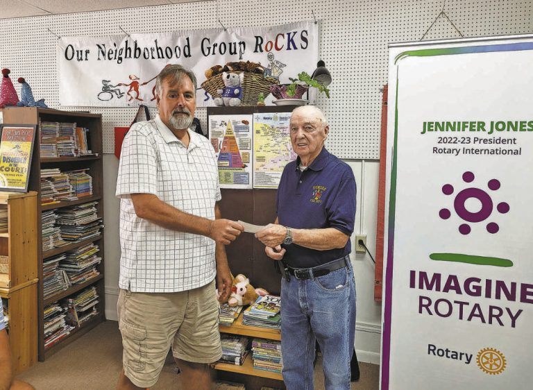 Dundee Rotarian and Past President Walt Verdi presents a check for $1,000 to Ray Miller of the Dundee Emergency Squad. PROVIDED PHOTO